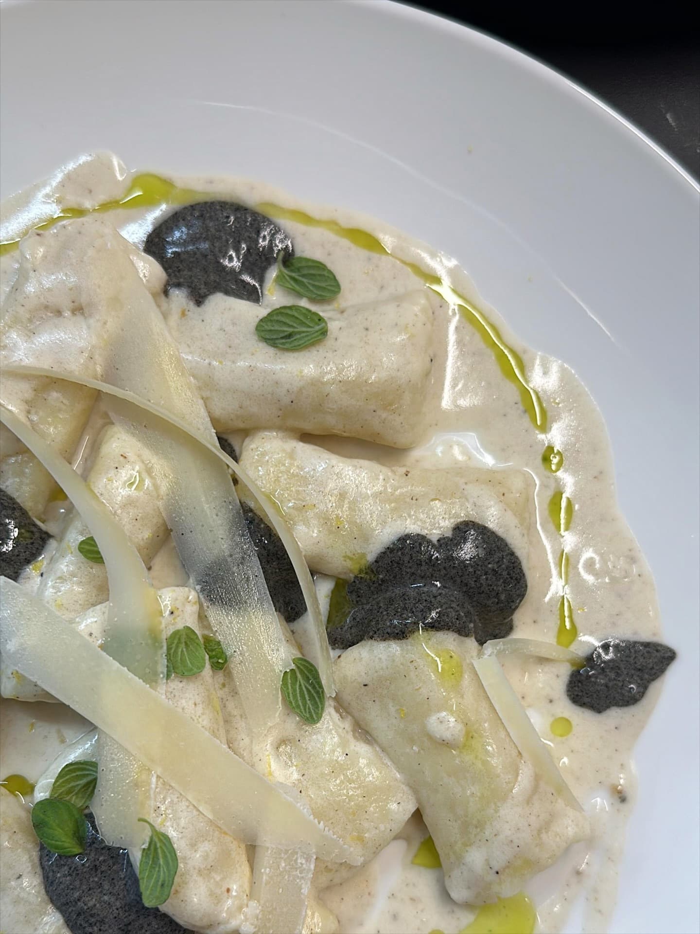 Gnocchi with buttery lemon sauce, burnt eggplant shell creme, oregano, parmesan cheese